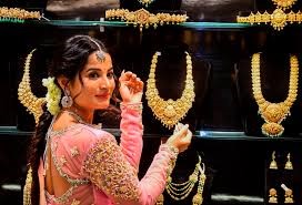 Gold jewelry with rising price chart indicating market trends